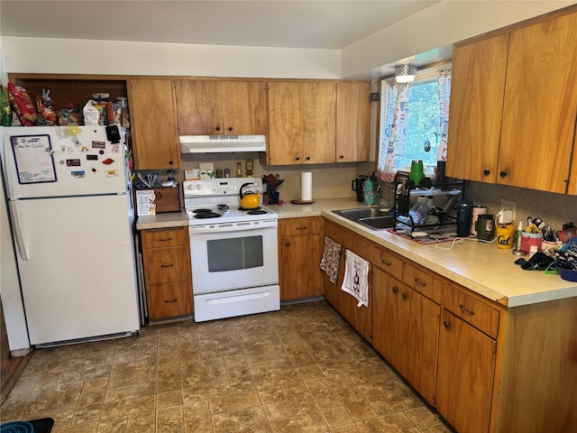 kitchen with white appliances, under cabinet range hood, and light countertops