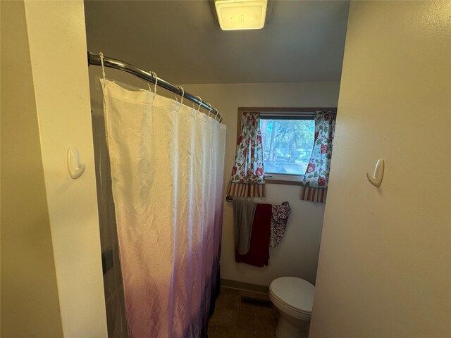 full bathroom with toilet, baseboards, curtained shower, and tile patterned flooring