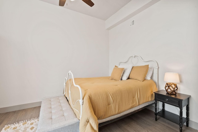 bedroom with visible vents, ceiling fan, and wood finished floors