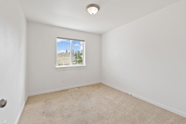carpeted empty room with baseboards and visible vents