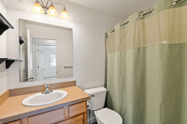bathroom featuring vanity, toilet, and curtained shower