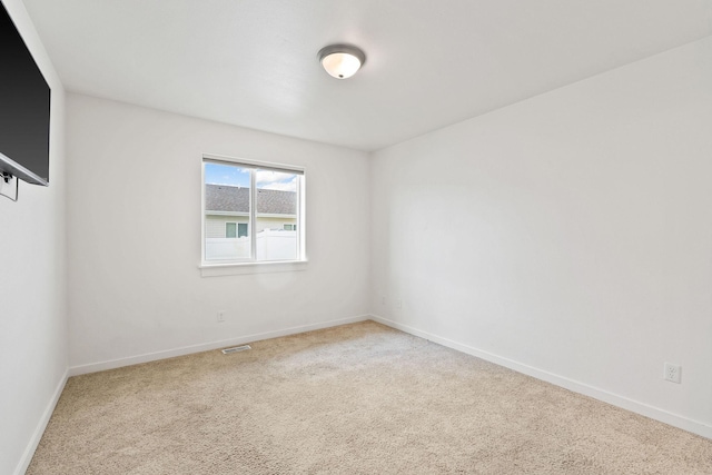 carpeted empty room with baseboards and visible vents