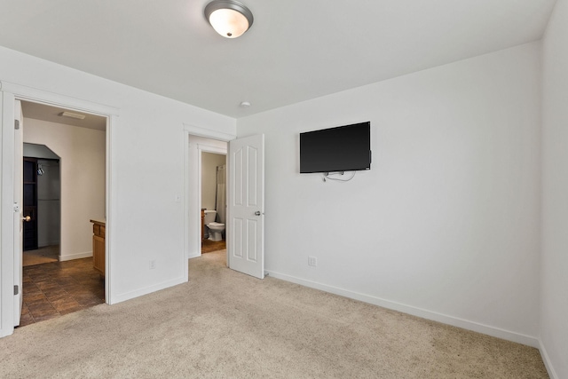 unfurnished bedroom with carpet floors and baseboards