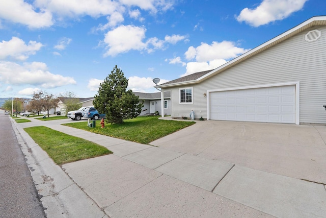view of front of house with a garage, driveway, and a front yard