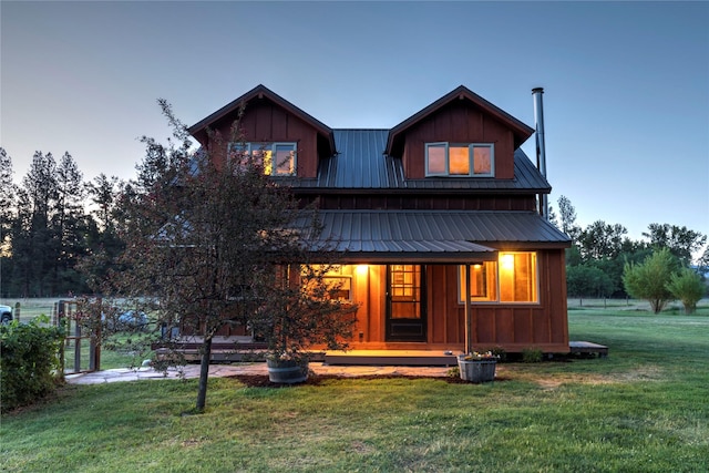 85 Martin Ln, Florence, MT 59833 - view of front of property featuring covered porch, metal roof, a yard, and board and batten siding