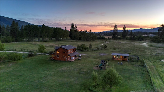 85 Martin Ln, Florence, MT 59833 - yard at dusk with a rural view, an outbuilding, a mountain view, and a barn