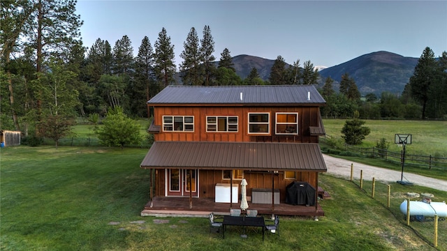 85 Martin Ln, Florence, MT 59833 - rear view of house featuring board and batten siding, metal roof, and a mountain view