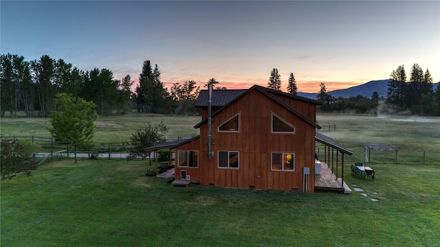 view of side of property with a yard, crawl space, and fence