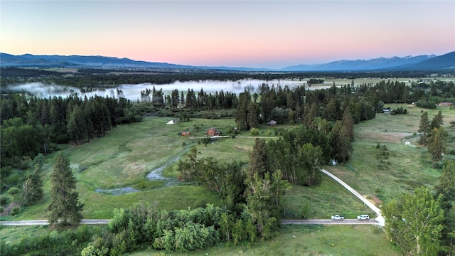aerial view at dusk with a water and mountain view