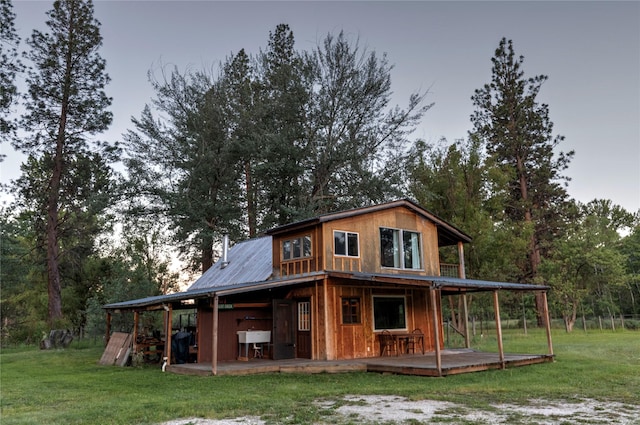 85 Martin Ln, Florence, MT 59833 - back of house featuring a lawn, metal roof, and a wooden deck