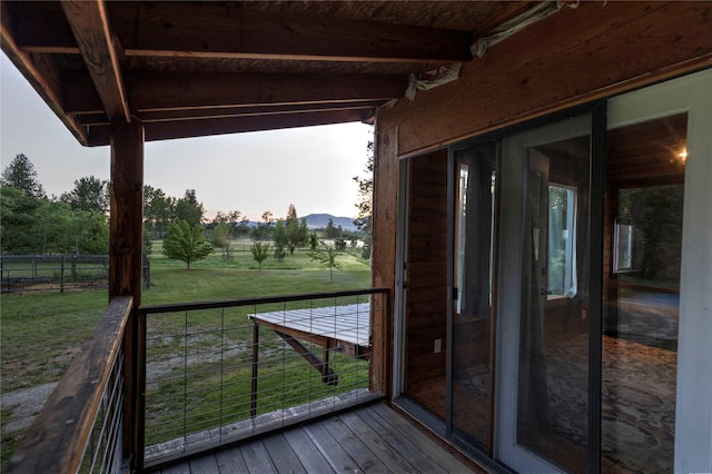 deck with a mountain view and a yard