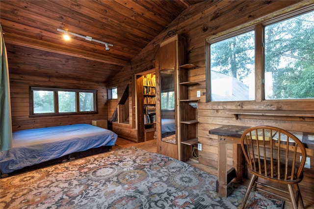 85 Martin Ln, Florence, MT 59833 - bedroom featuring rail lighting, vaulted ceiling, wood walls, wooden ceiling, and carpet