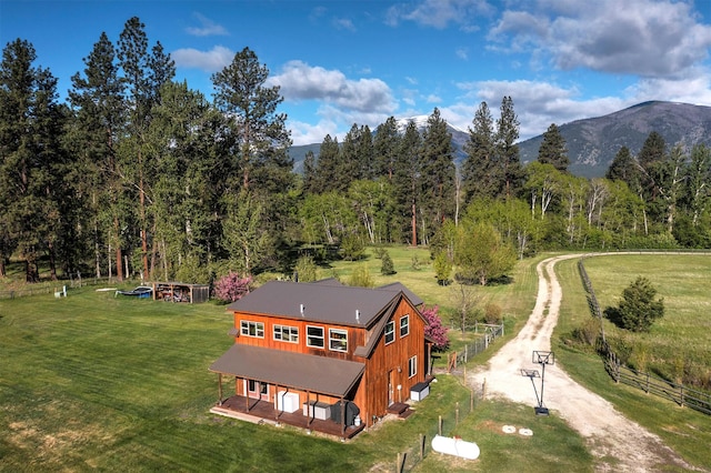 85 Martin Ln, Florence, MT 59833 - view of subject property with a mountain backdrop and a heavily wooded area