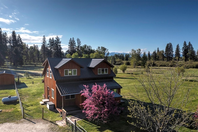 85 Martin Ln, Florence, MT 59833 - view of front facade with metal roof, a front lawn, and cooling unit