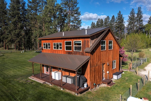 85 Martin Ln, Florence, MT 59833 - back of house with metal roof, a yard, and board and batten siding