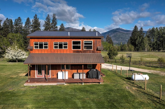 85 Martin Ln, Florence, MT 59833 - rear view of property featuring board and batten siding, metal roof, and a mountain view