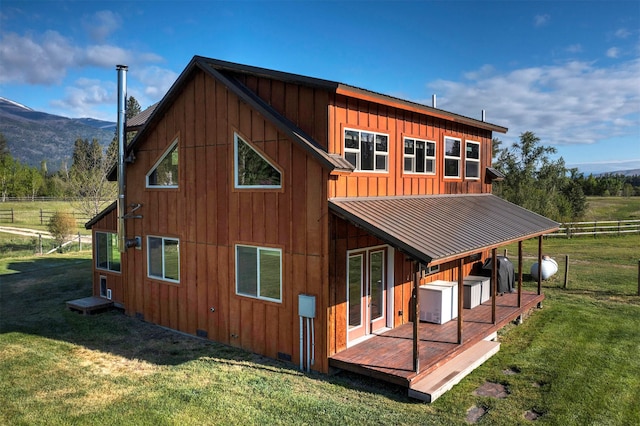 85 Martin Ln, Florence, MT 59833 - rear view of property featuring board and batten siding, a deck with mountain view, metal roof, and a standing seam roof