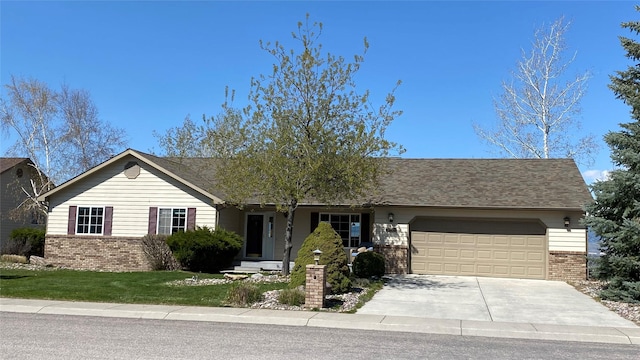 ranch-style home featuring brick siding, driveway, a front lawn, and a garage