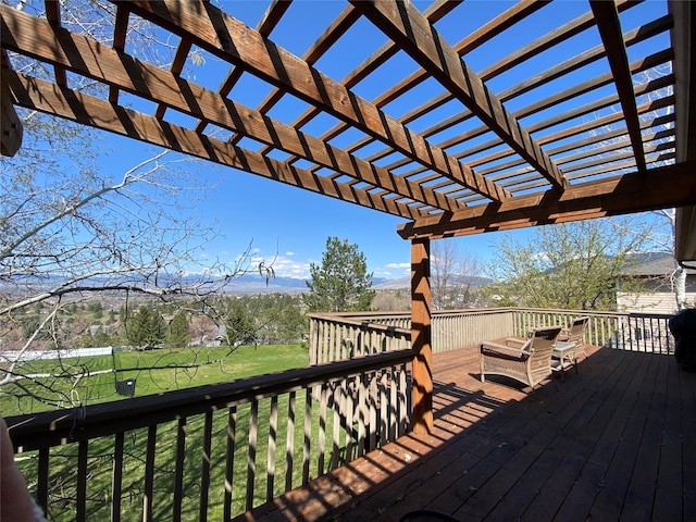 deck with a pergola and a yard