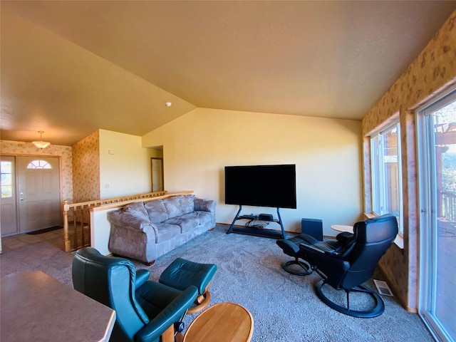 carpeted living room with baseboards, plenty of natural light, and lofted ceiling