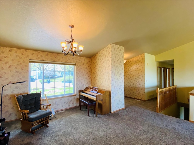sitting room featuring visible vents, carpet floors, baseboards, an inviting chandelier, and wallpapered walls