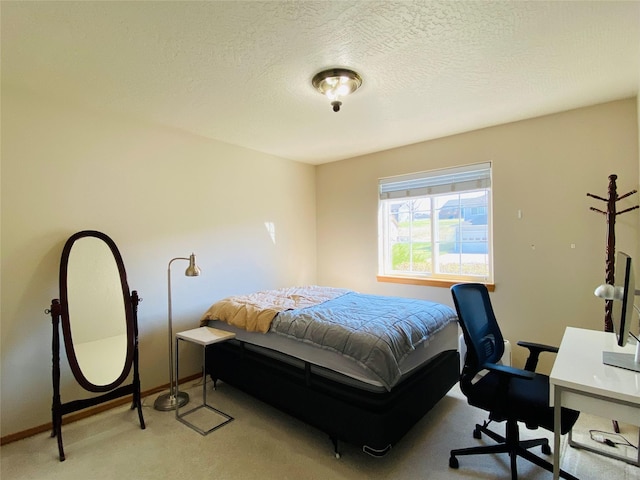 bedroom with baseboards, carpet, and a textured ceiling