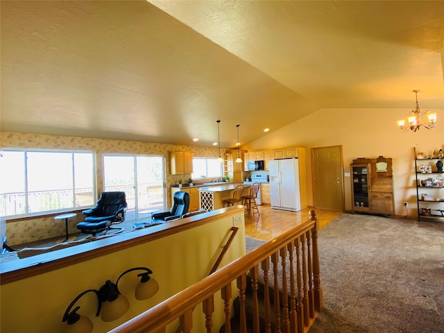 interior space featuring lofted ceiling and a notable chandelier