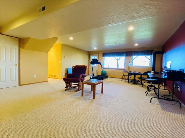sitting room with carpet floors, recessed lighting, and visible vents