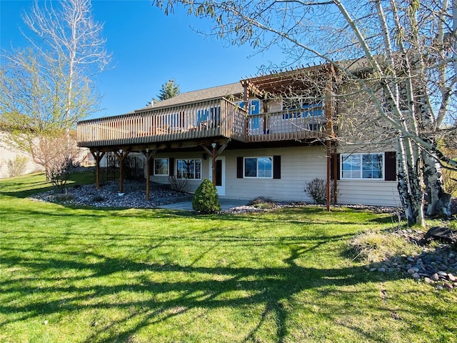 rear view of house with a lawn and a deck