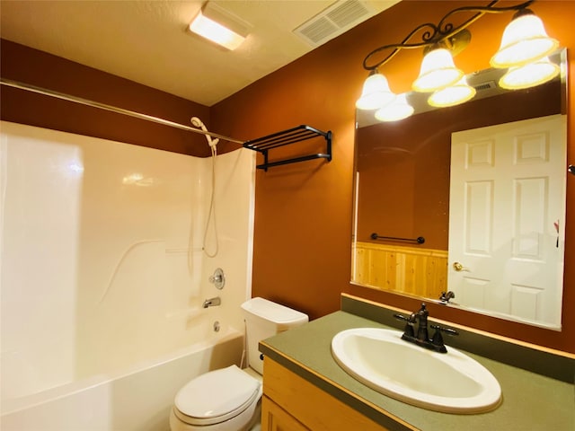 bathroom featuring toilet, visible vents, shower / washtub combination, and vanity