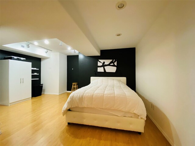 bedroom with baseboards and light wood-style floors
