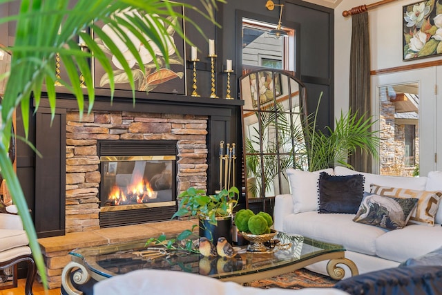 living room with a stone fireplace