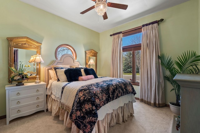 bedroom with baseboards, light colored carpet, and ceiling fan