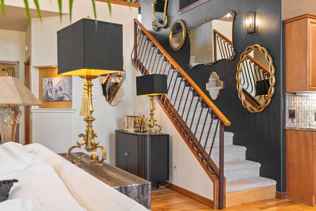 stairway featuring baseboards and wood finished floors