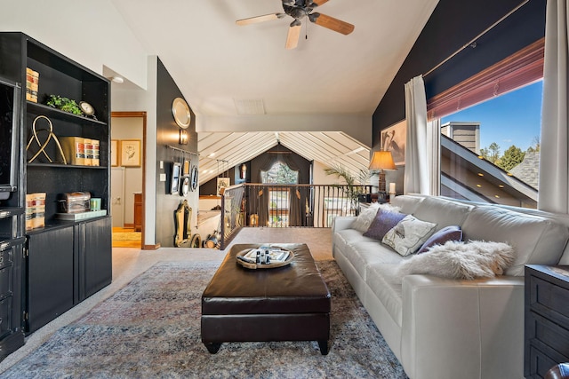 living room with plenty of natural light, a ceiling fan, and vaulted ceiling