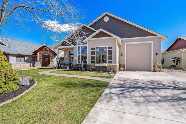 craftsman-style home featuring a front yard, driveway, an attached garage, and stone siding