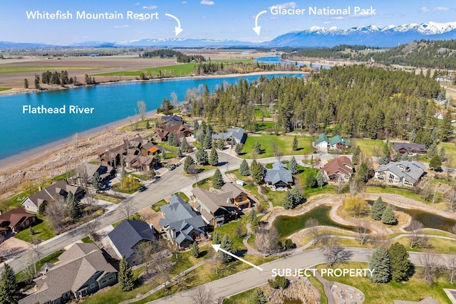 birds eye view of property with a residential view and a water and mountain view