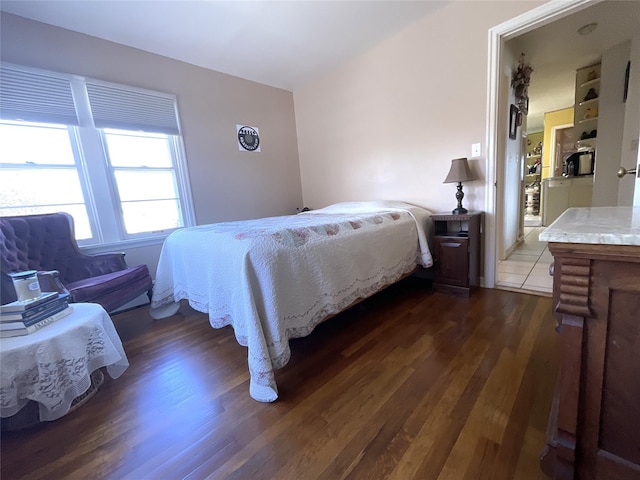 bedroom with dark wood-style floors