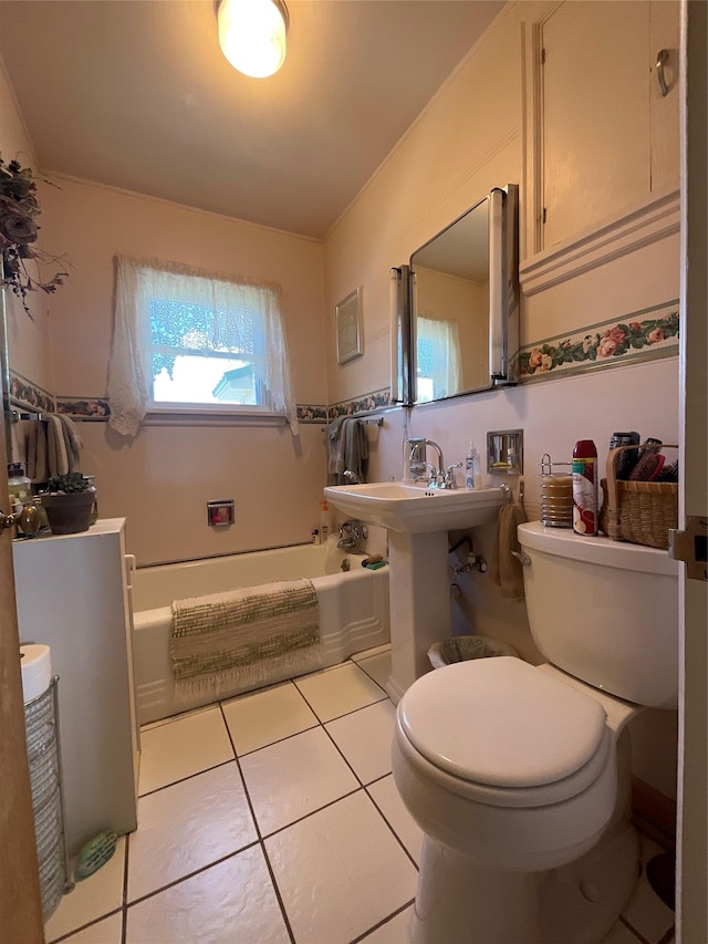 bathroom with tile patterned flooring, a bath, and toilet