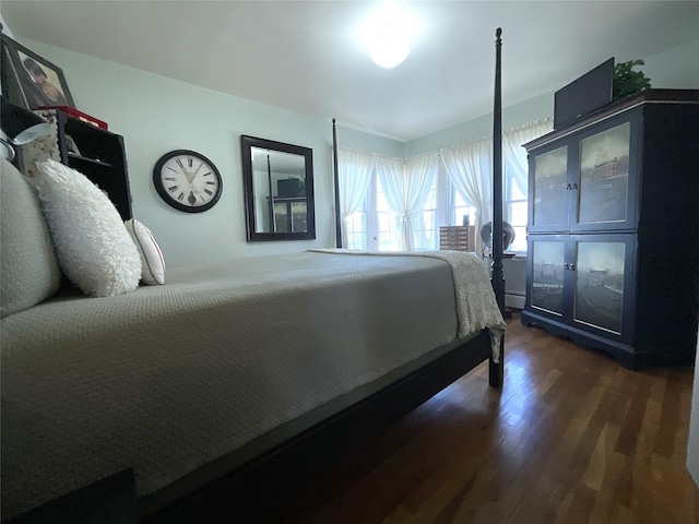 bedroom with dark wood finished floors