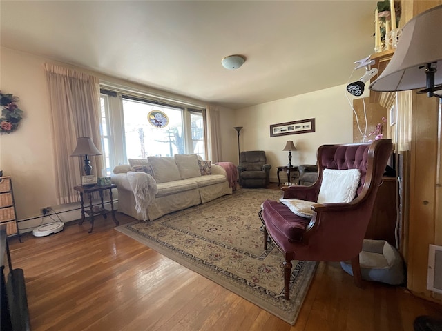 living area with a baseboard radiator and wood finished floors