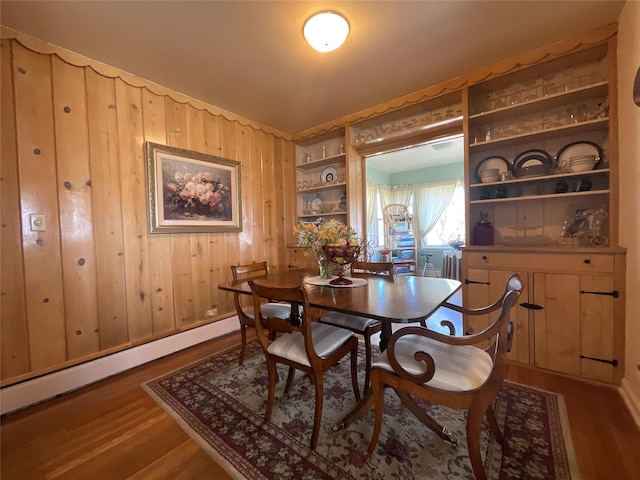 5 W 1st St, Whitehall, MT 59759 - dining space with a baseboard radiator, dark wood finished floors, and wood walls