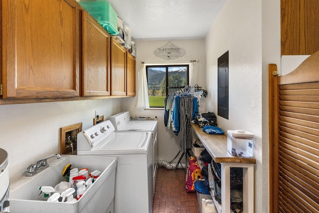 laundry area featuring independent washer and dryer, cabinet space, a sink, brick patterned floor, and electric panel
