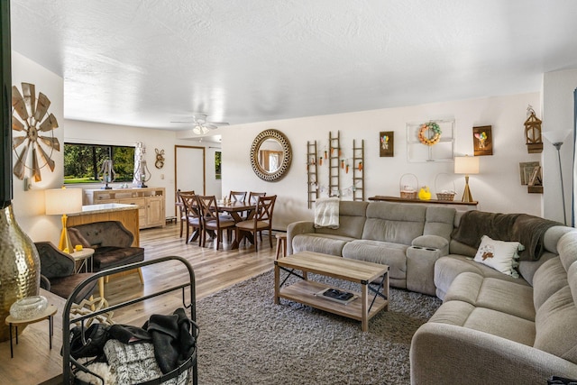 living room with light wood-type flooring and ceiling fan