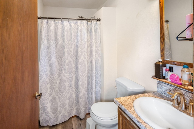 full bathroom featuring vanity, wood finished floors, toilet, and a shower with curtain