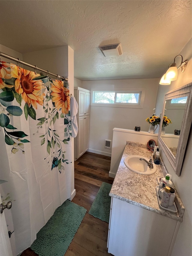 509 N 5th St, Hamilton, MT 59840 - bathroom featuring vanity, baseboards, wood finished floors, and visible vents