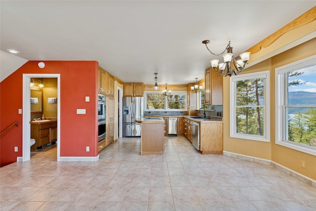 7100 Black Lake Rd, Rexford, MT 59930 - kitchen featuring a chandelier, appliances with stainless steel finishes, a center island, light countertops, and light tile patterned floors