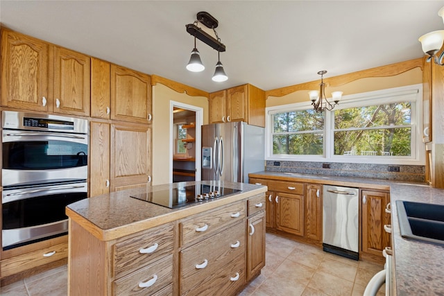 kitchen featuring pendant lighting, appliances with stainless steel finishes, a center island, light tile patterned floors, and an inviting chandelier