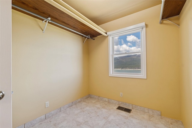 spacious closet featuring visible vents