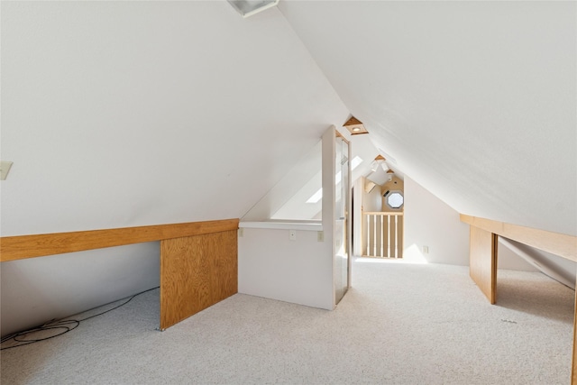 bonus room with carpet and vaulted ceiling